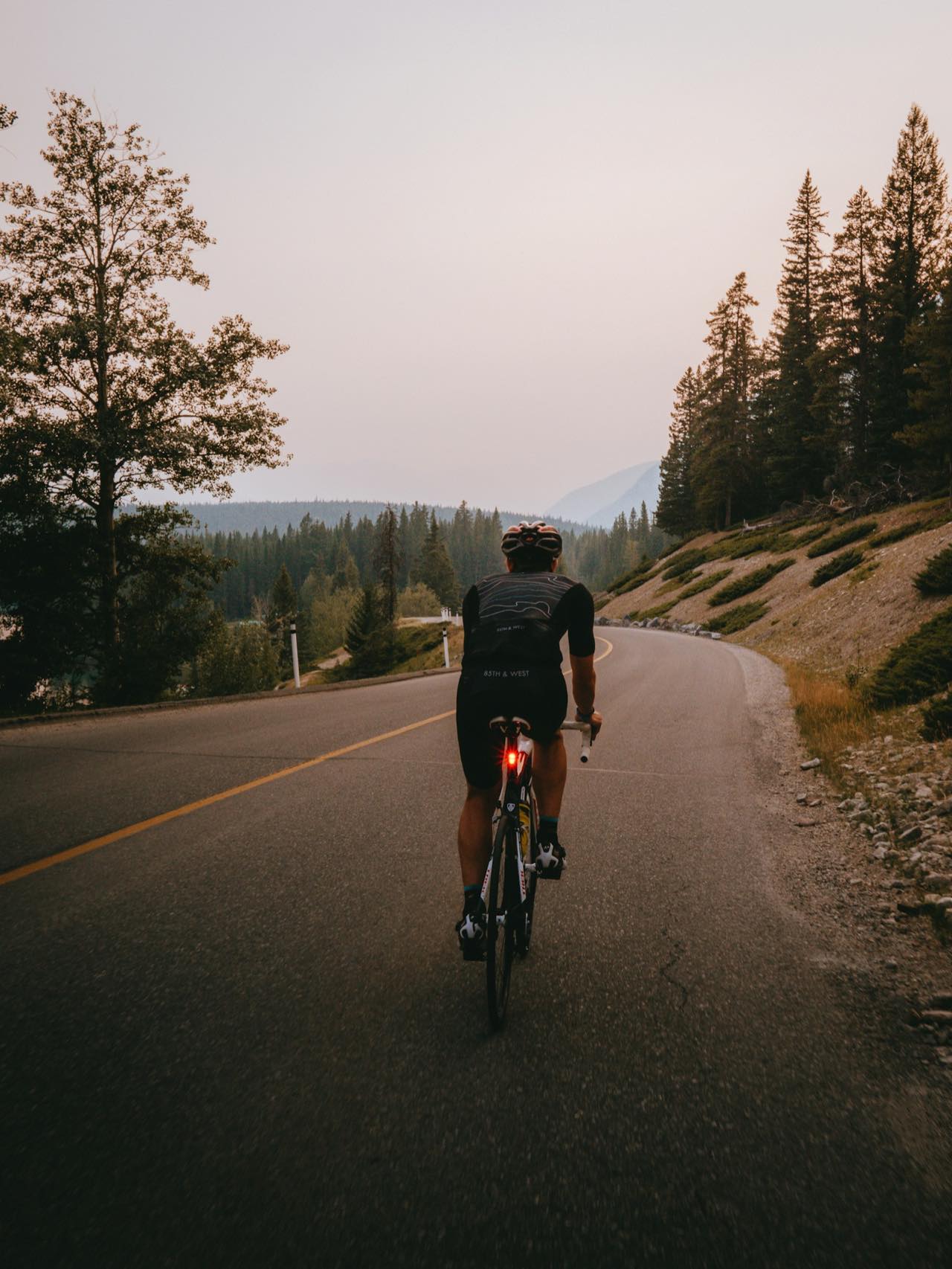 A cyclist on a quiet road in the fall